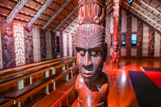 Maori carving and interior of meeting house