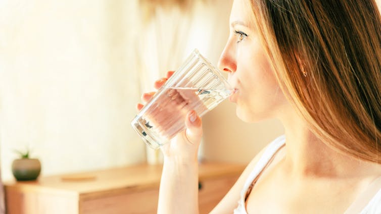 woman drinks glass of water