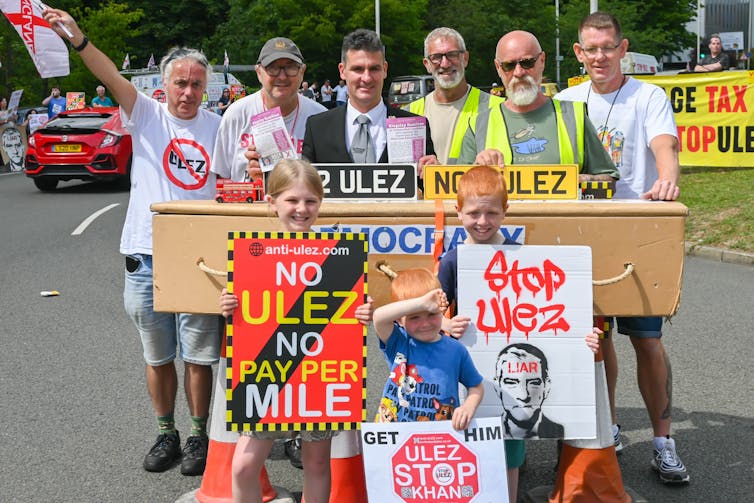 Protestors with colourful banners and posters.
