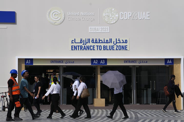 People walk by the entrance to the blue zone.