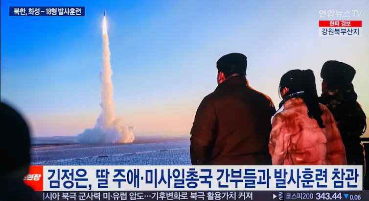A missile is seen being fired into the air trailed by a plume of smoke.