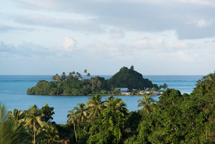 A hilly tropical island surrounded by the ocean