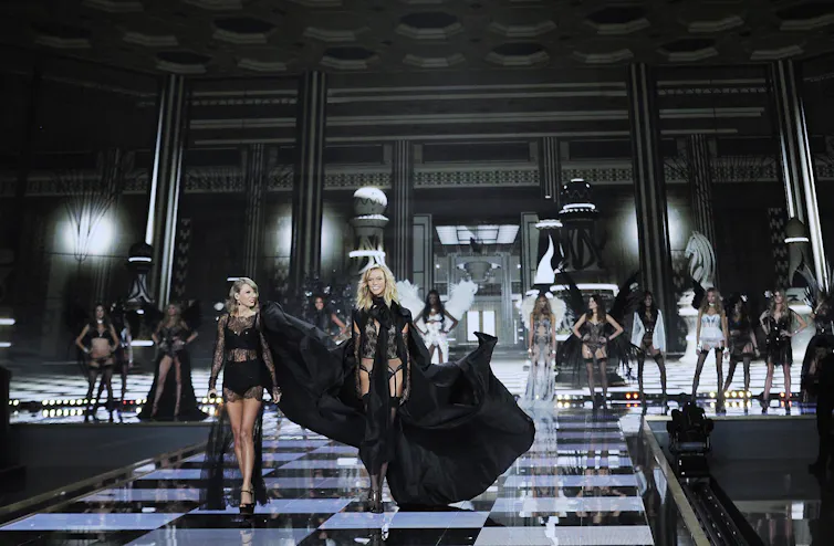 A cat walk, both dressed in black