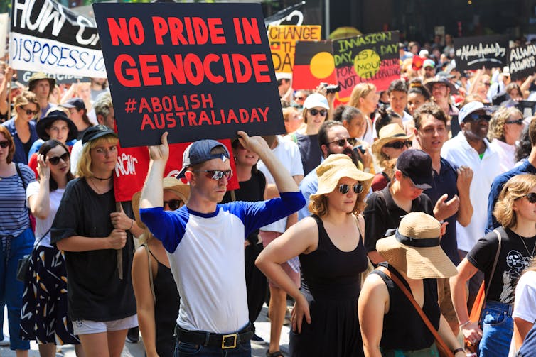 Large group of men and women protesting against Australia Day