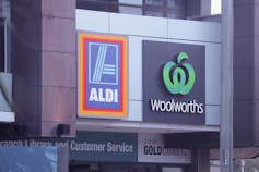 Signs promoting Aldi and Woolworths