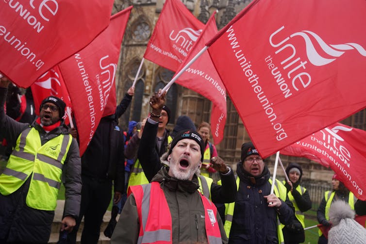 Protesters with large Unite union flags