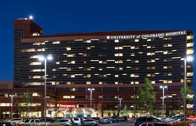 University of Colorado Hospital, seen at night with its parking lot out front