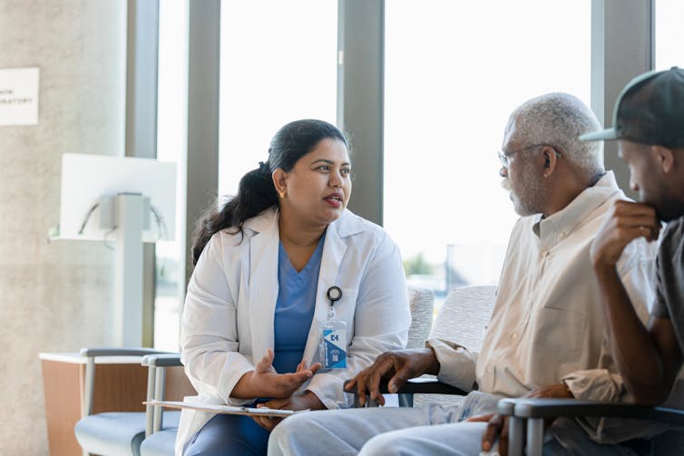 Doctor talking with patient and caregiver