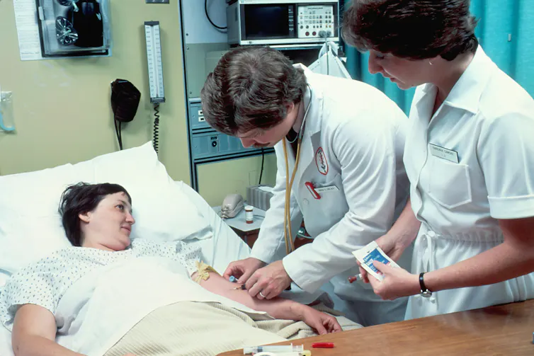 Doctor draws blood from patient