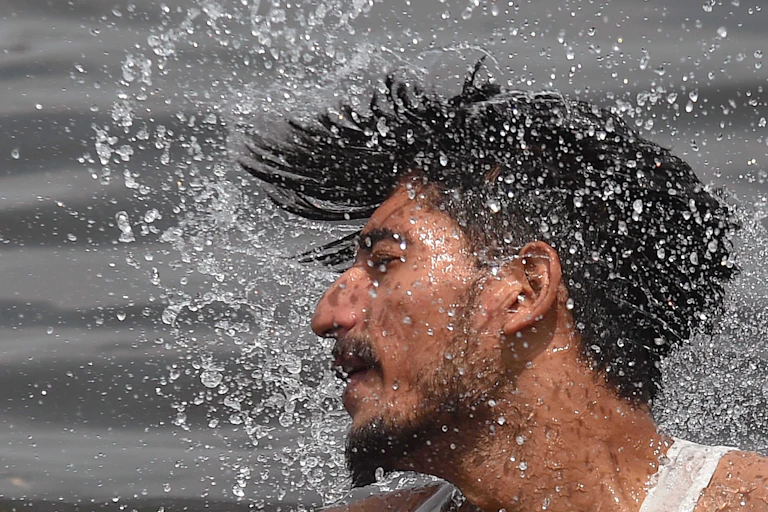 man spraying water from his hair