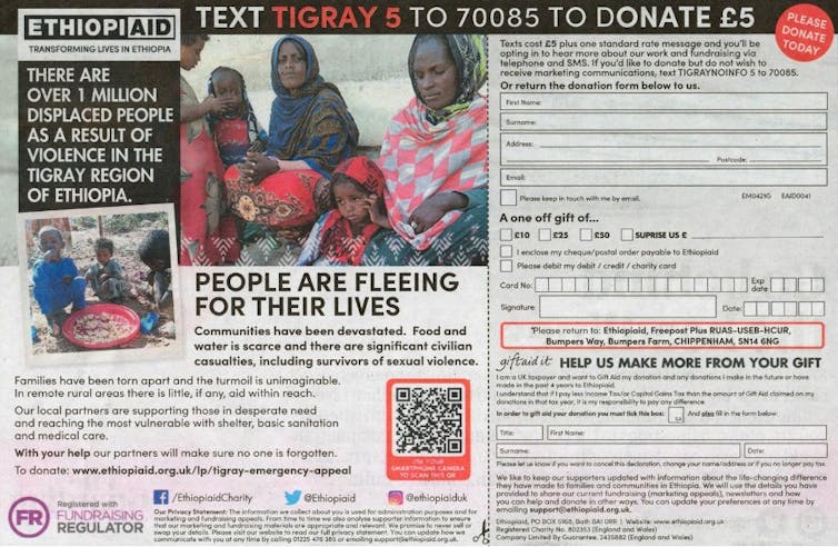 A charity advert in a newspaper with a picture of women and children in rural Ethiopia.
