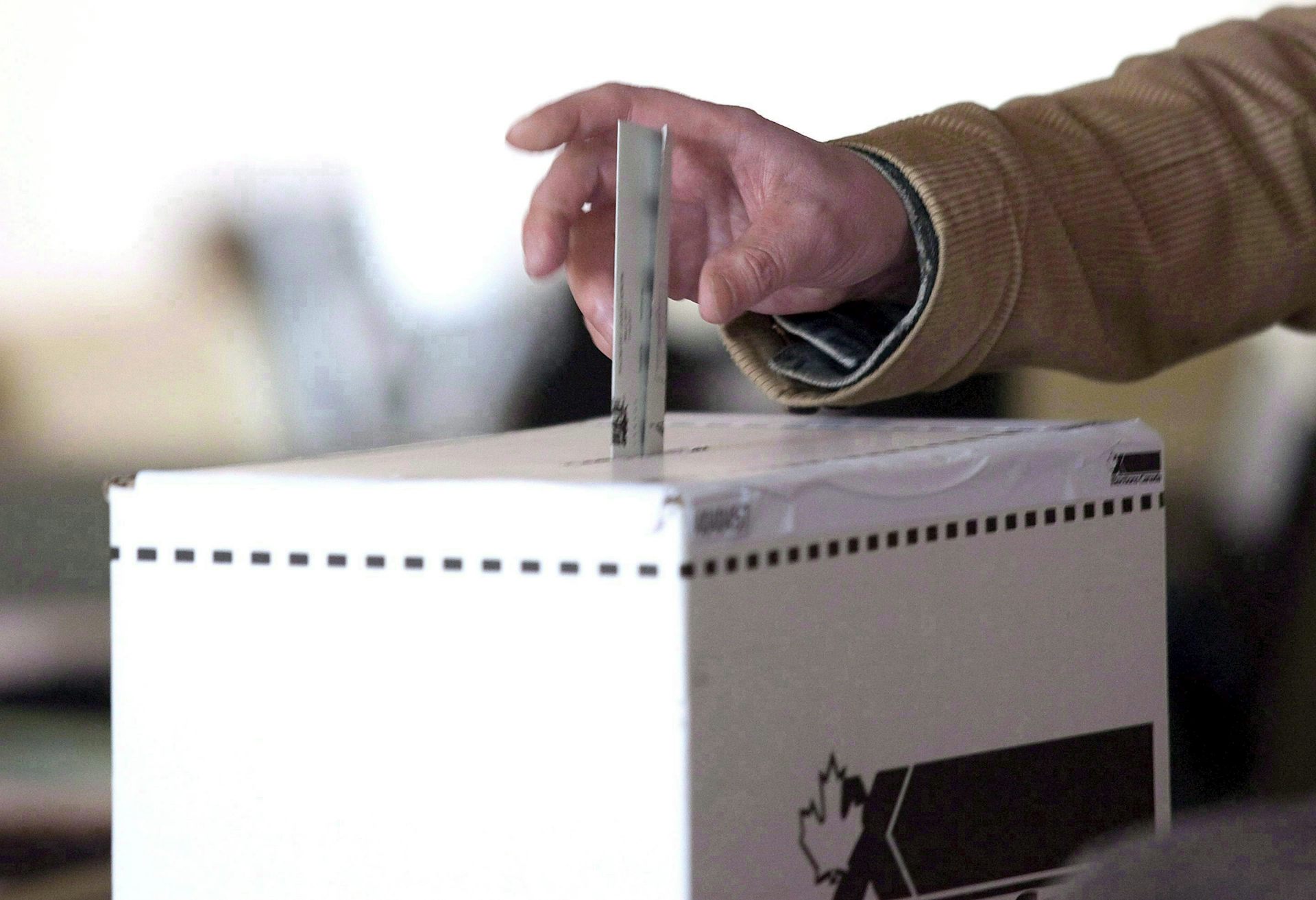 Some puts their ballot into a ballot box in the 2011 federal election.
