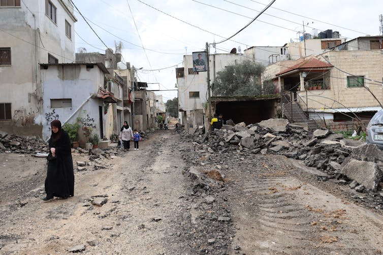 A woman in a buurqa walks on a street in Jenin refugee camp on the West Bank, January 25.