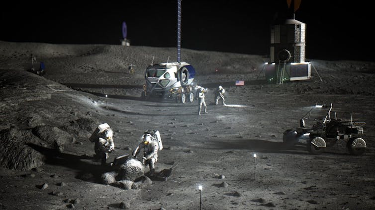 Astronauts study Moon's surface with various vehicles in the background