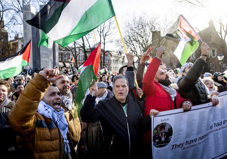 A crowd of protesters waving Palestinian flags.