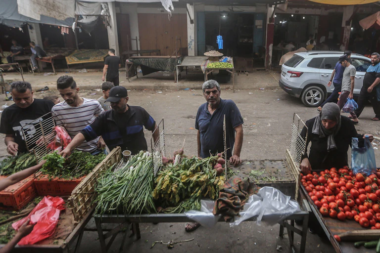 Men selling fresh food from stalls.