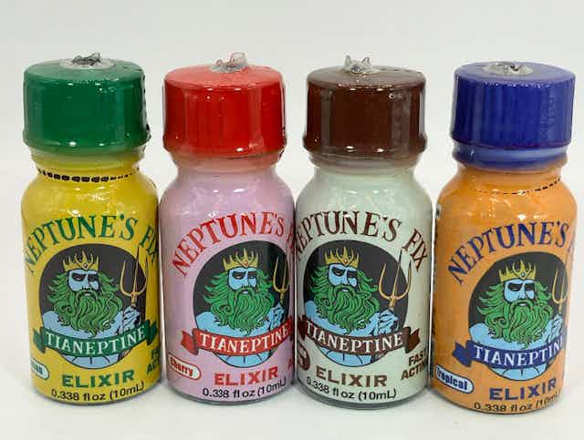 Four bottles of the tianeptine-containing product Neptune's Fix lined up side by side. 