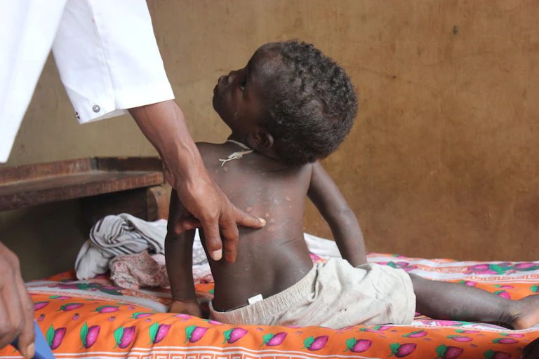 Toddle r being examined by healthcare worker