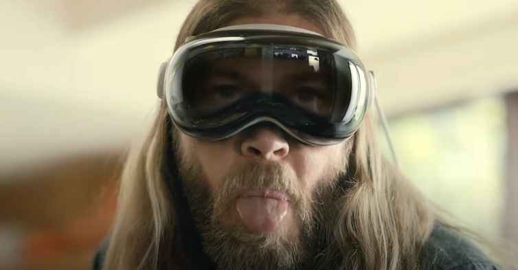 A man wearing goggles with a screen that shows his eyess