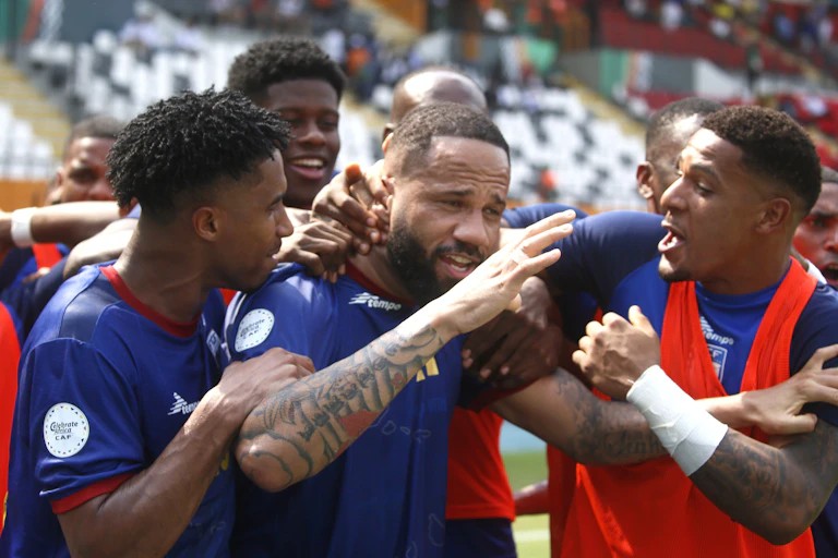 A football team celebrating scoring a goal.