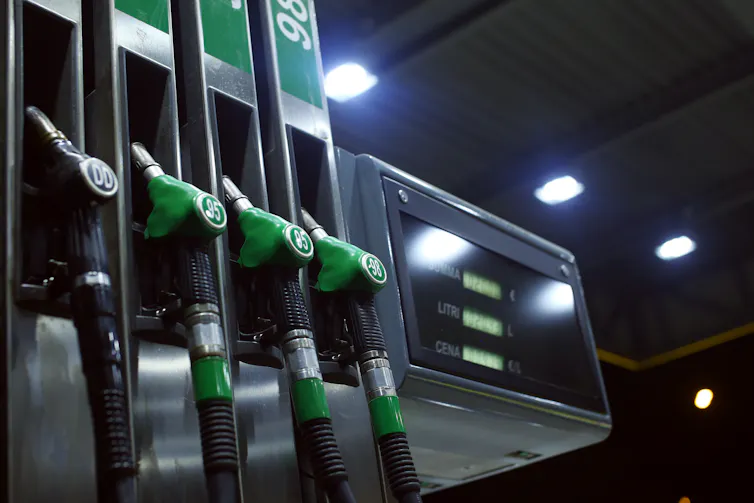 Four diesel pumps in a station forecourt at night.