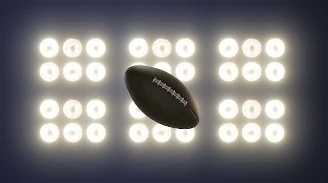 A football is illuminated by 36 spotlights.