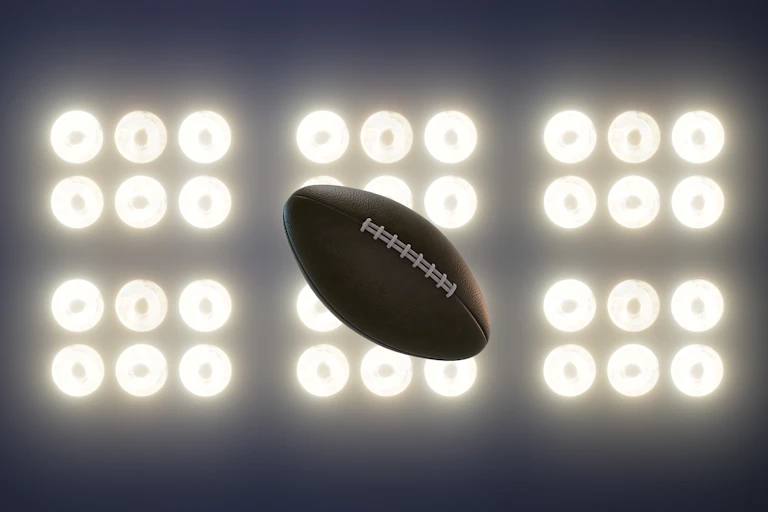 A football is illuminated by 36 spotlights.
