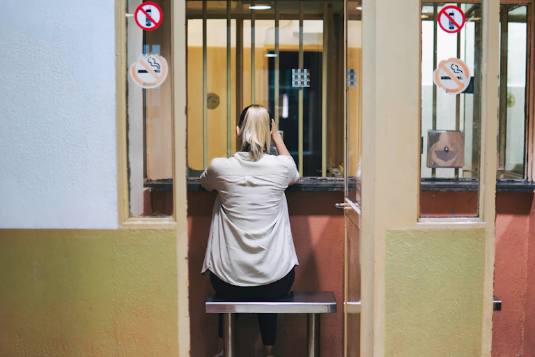 The back of a woman in a prison visitation area