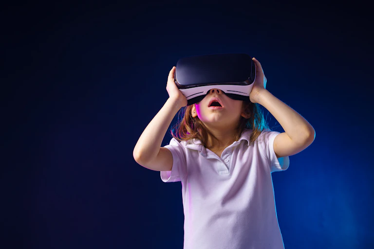 A young child wearing a VR headset looking thrilled with what they see