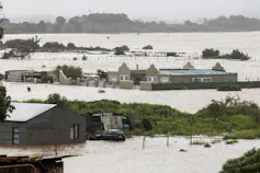 A community of houses with water flooding up to window level