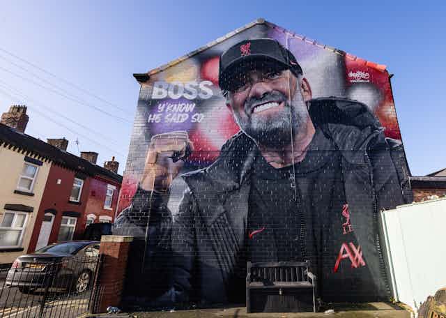 A mural of Jürgen Klopp on the side of a house.