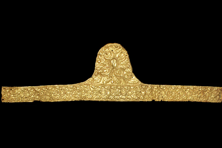 Gold band with ornate detailing against a black backdrop