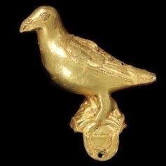 A bird-shaped cast gold ornament.