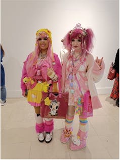Two women dressed in pink and cute accessories