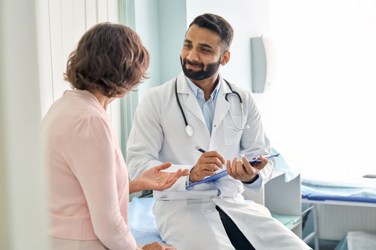 Doctor with a clipboard talking to a patient