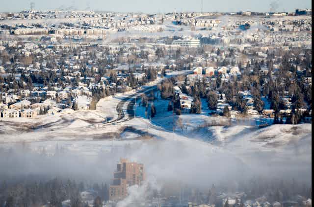 Rows of houses are seen against a snowy landscape.