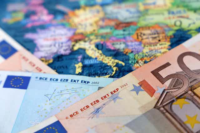 Euro banknotes on a map of Europe.