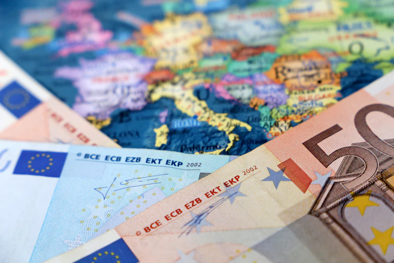 Euro banknotes on a map of Europe.