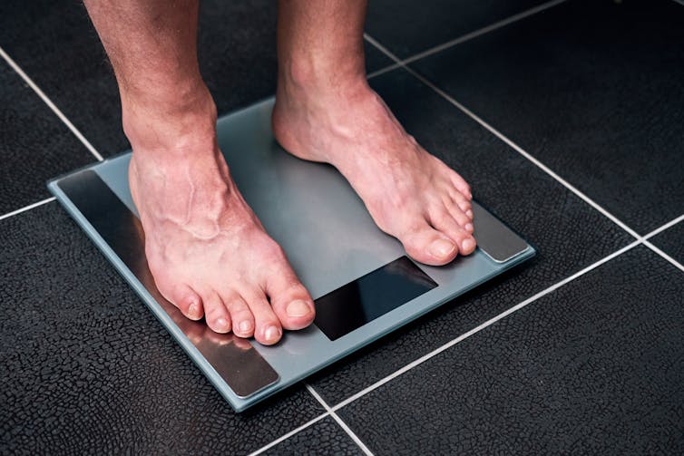 Man on bathroom scales