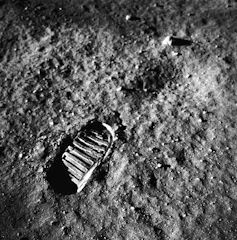 a black and white photo of a footprint on a sedimentary surface