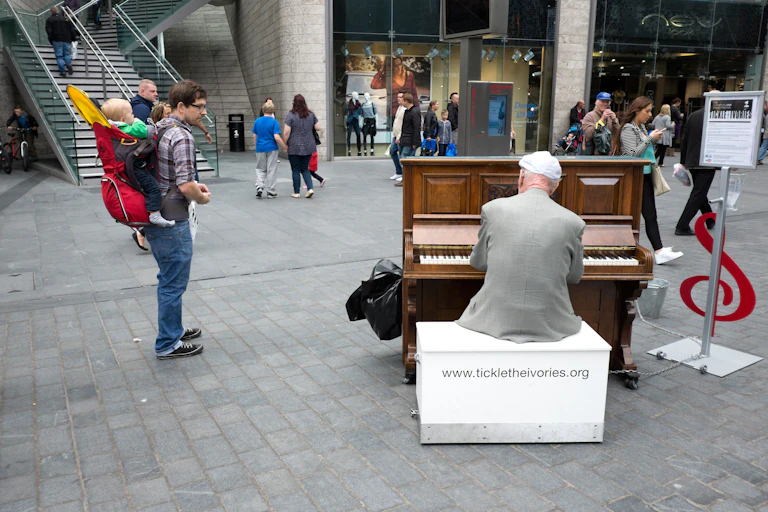 Older man playing the piano at a shopping mall