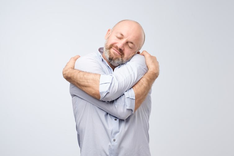 Man hugging himself