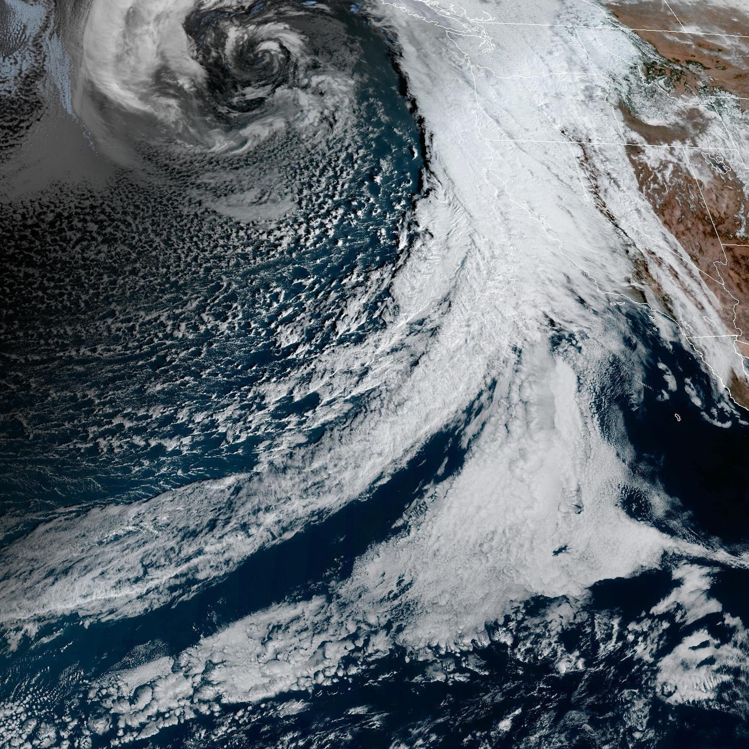 A band of clouds stretches from Hawaii to California and Oregon.