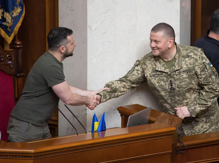 Commander-in-Chief of the Armed Forces of Ukraine Major General Valeriy Zaluzhny shakes hands with Ukrainian President Volodymyr Zelenskyy