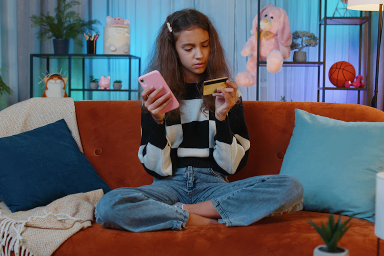 Girl with bank card and mobile phone
