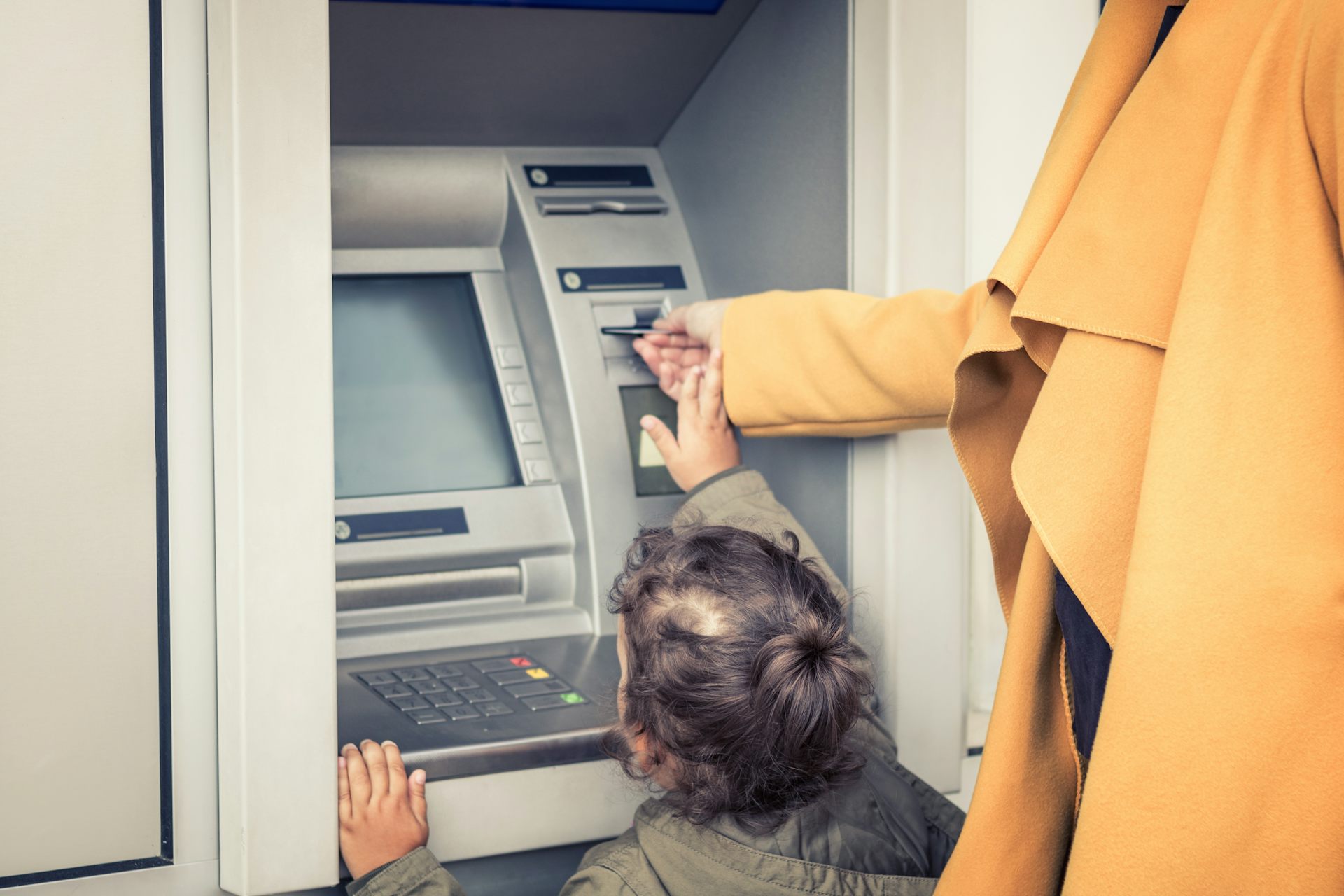 Mother and child at ATM