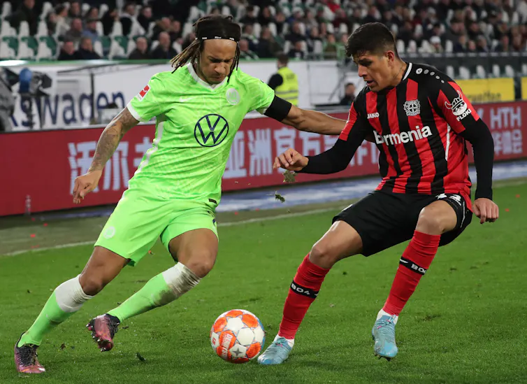 Two footballers in action