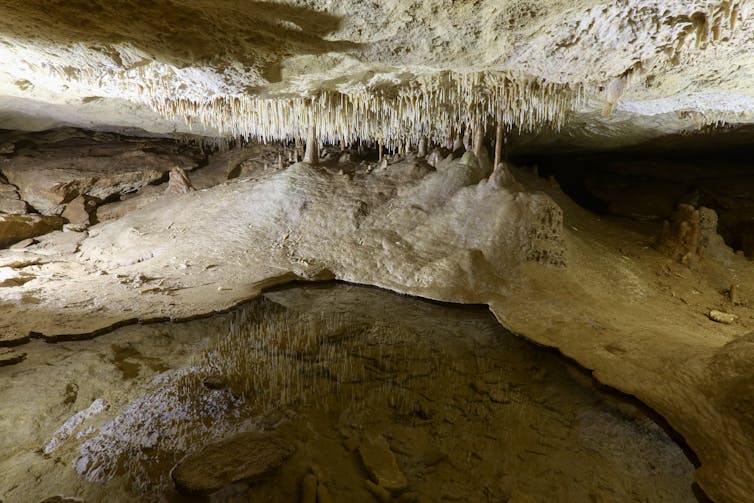 A photo of a pool of water in a cave.
