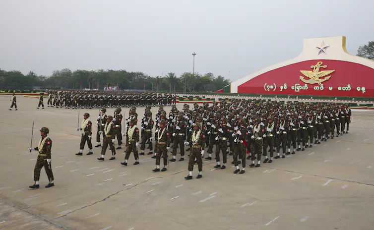 Men in uniform take part in a military parade.