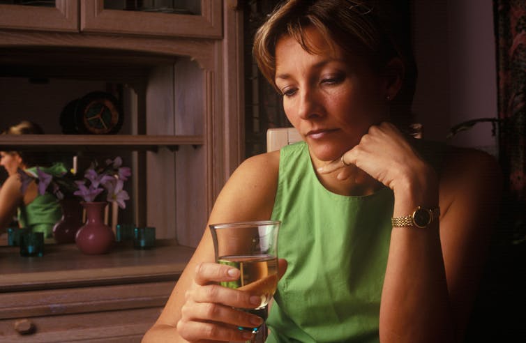 Woman holding a glass of white wine